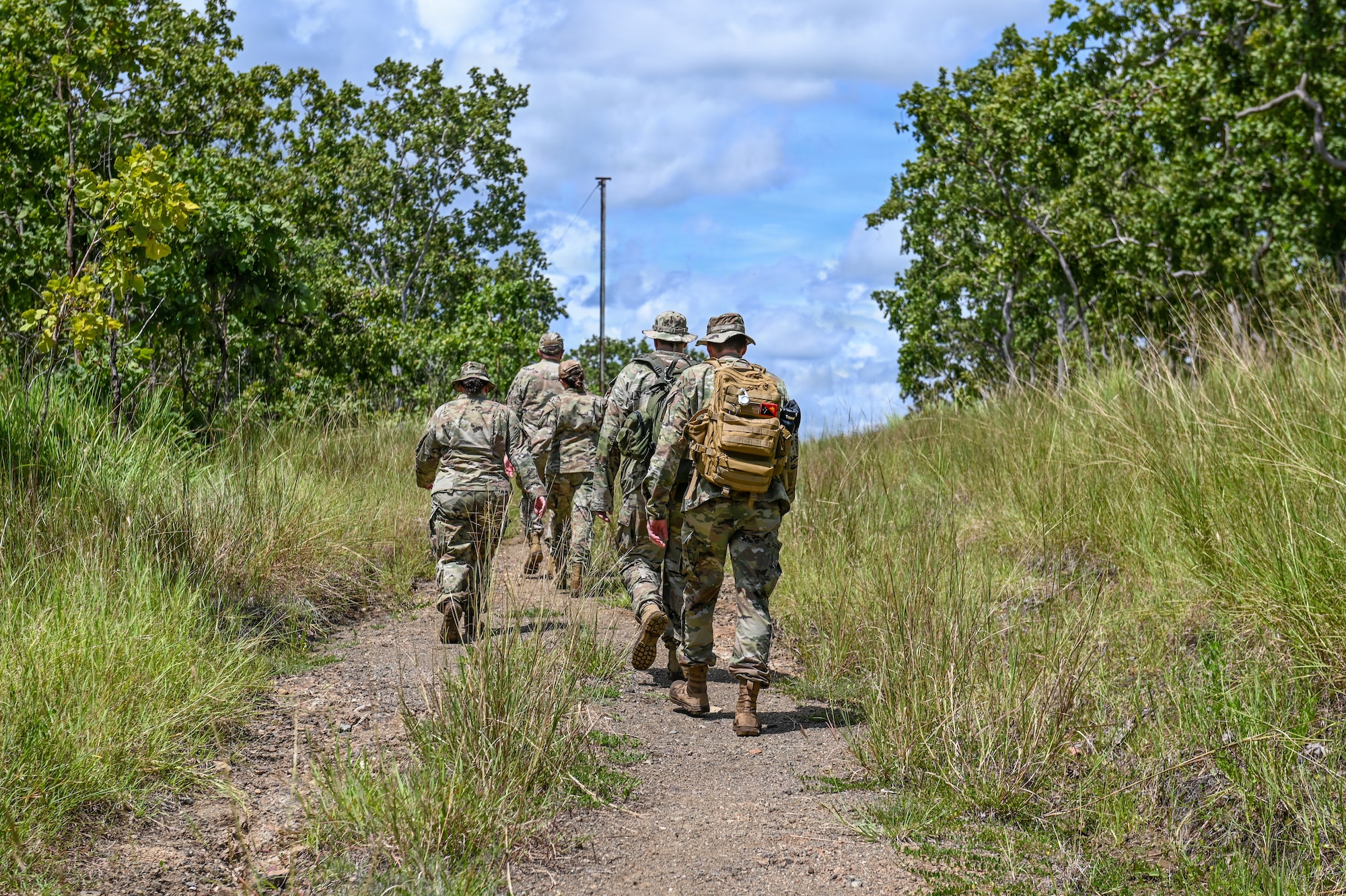 U.S. Airmen assigned to the Wisconsin Air National Guard, retrace the steps the 32nd Division took during their march across New Guinea on the Gaba Gaba trail, National Capital District, Papua New Guinea, March 17, 2025. The Wisconsin National Guard traveled to PNG as part of the State Partnership Program subject matter expert exchange. (U.S. Air National Guard photo by Master Sgt. Mary Greenwood)