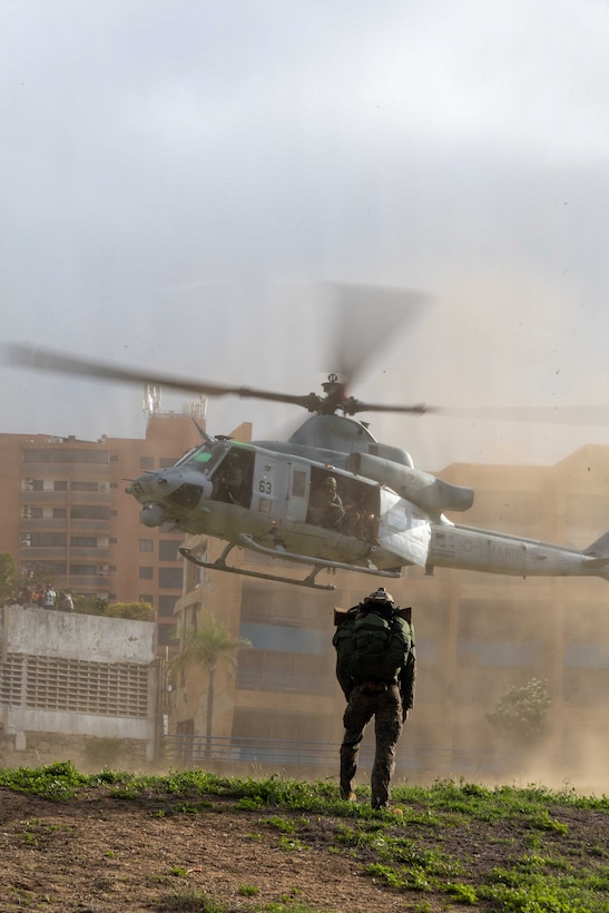 A U.S. Marine with Maritime Raid Force, Littoral Combat Force-24, watches a UH-1Y Venom with Marine Medium Tiltrotor Squadron (VMM) 365 (Reinforced), LCF-24, depart the landing zone in La Guaira, Venezuela, June 27, 2026. At the direction of U.S. Southern Command, assigned U.S. military forces are supporting Department of State-led U.S. disaster assistance to the people of Venezuela in the aftermath of the June 24, 2026, earthquakes. (U.S. Marine Corps photo)