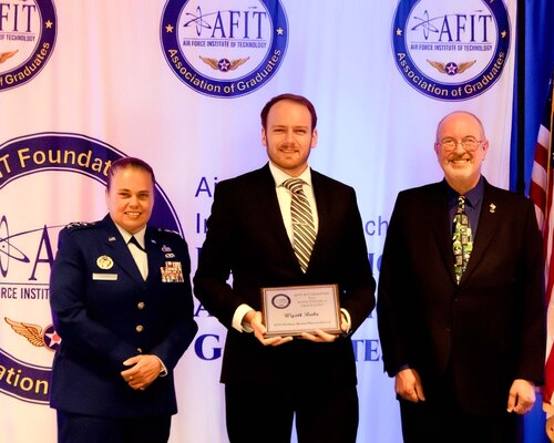 The Air Force Institute of Technology and the AFIT Foundation and Association of Graduates recognized five alumni for their outstanding career achievements in a ceremony on  June 19.  Lt. Gen. Linda S. Hurry, commander, Air Force Materiel Command, and AFIT alumnus, was the featured speaker.  The Young Alumni Award was presented to Wyatt Rabe (center) by Lt. Gen. Linda S. Hurry, commander, Air Force Materiel Command (left) and Dr. Lance Chenault, AFIT Foundation and Association of Graduates president (right).