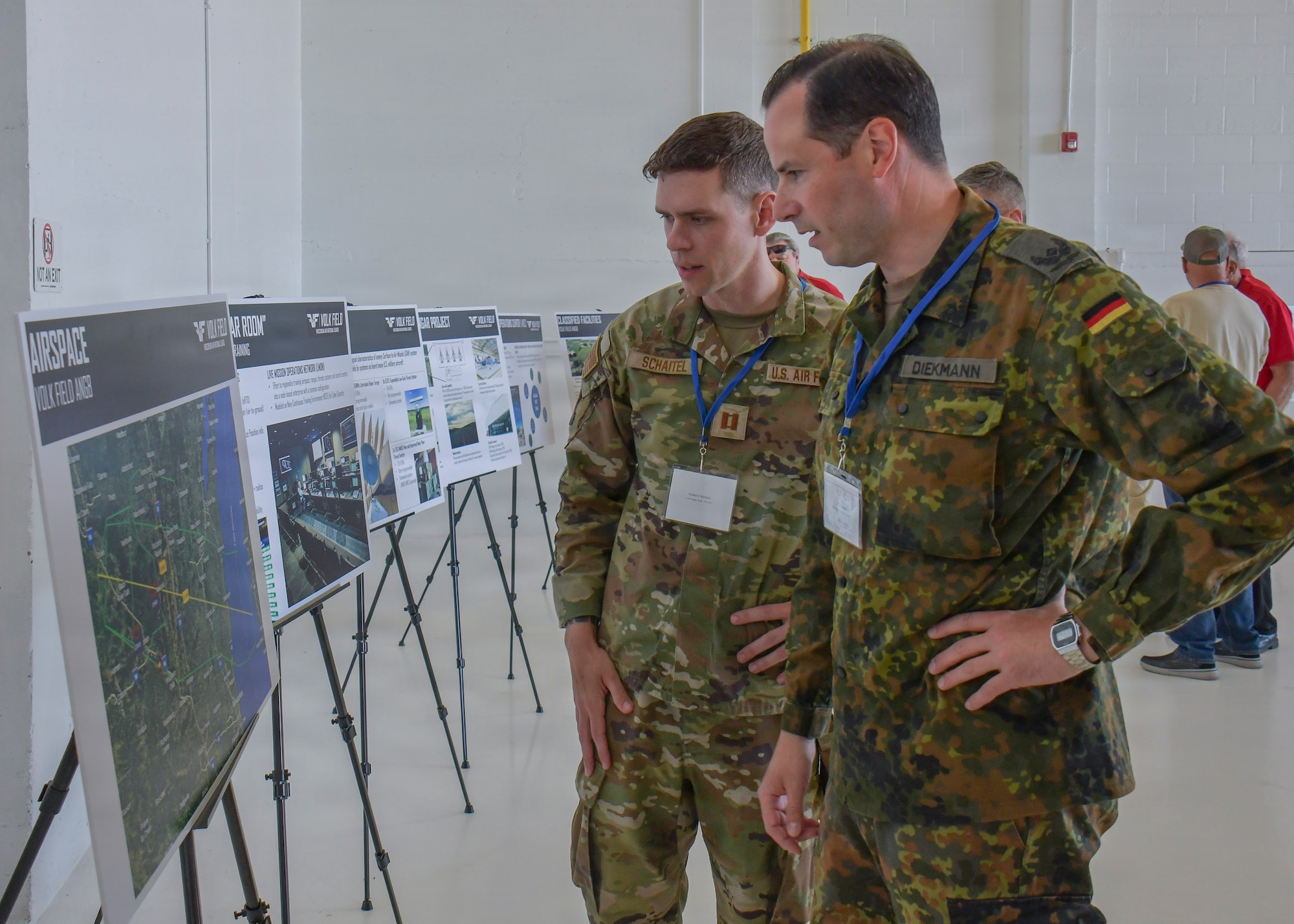 U.S. Air Force Capt. Andrew Schaitel, left, the operations officer assigned to the Wisconsin Air National Guard's 115th Security Forces Squadron, introduces German Air Force Maj. Robert Diekmann, a force protection officer assigned to the German Air Force Headquarters in Berlin, to the dedicated military airspace of Volk Field Combat Readiness Training Center in Camp Douglas, Wisconsin, June 4, 2026. Diekmann’s visit to Volk Field was part of the 2026 Sentry North distinguished visitor tour which offered military and civilian dignitaries a firsthand look at the joint training opportunities provided by the annual National Guard exercise. (U.S. National Guard photo by Paul Gorman)