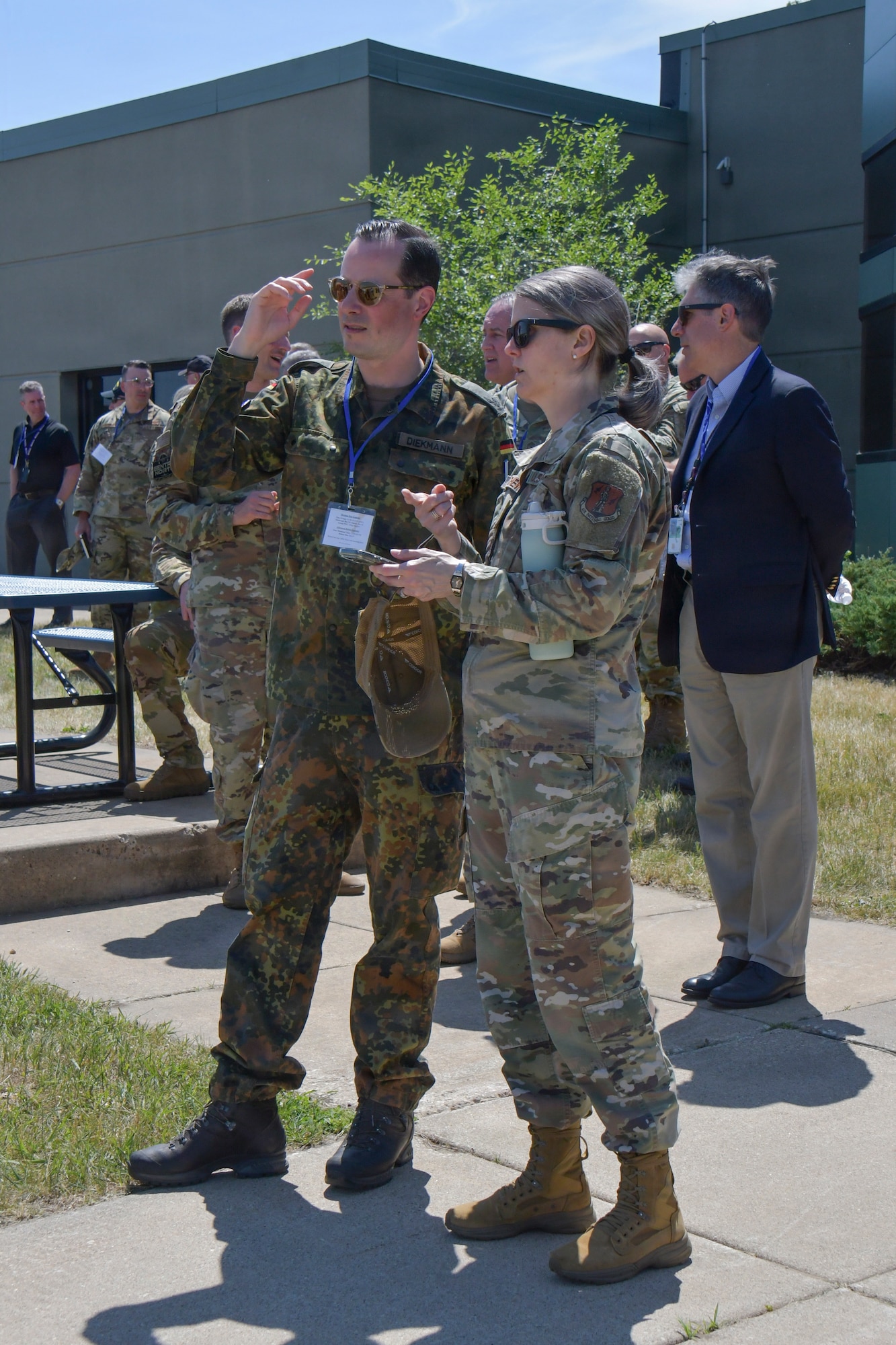 German Air Force Maj. Robert Diekmann, a force protection officer assigned to the German Air Force Headquarters in Berlin, and U.S. Air Force Chief Master Sgt. Maria Chew, command chief master sergeant for the Wisconsin Air National Guard’s 115th Fighter Wing, observe an aircraft launch June 4, 2026, during the Sentry North exercise at Volk Field Combat Readiness Training Center in Camp Douglas, Wisconsin. Diekmann’s visit to Volk Field was part of the exercise’s distinguished visitor tour which offered military and civilian dignitaries a firsthand look at the joint training opportunities provided by the annual National Guard exercise.