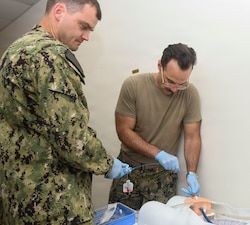 Lieutenant Commander Julian Deutsch, left, and Lieutenant Commander Justin Frisenda, assigned to Expeditionary Medical Facility Kilo, performs a resuscitative endovascular balloon occlusion of the aorta on a simulated casualty during a training at the NMCCL Healthcare Simulation and Bioskills Center, on June 23, 2026. EMF-Kilo is the expeditionary readiness platform attached to Navy Medicine Readiness and Training Command Camp Lejeune and is comprised of approximately hundreds of personnel ready to deploy field hospital capabilities during humanitarian or combat mission. (U.S. Navy photo by Mass Communications Specialist 2nd Class Justin Woods)