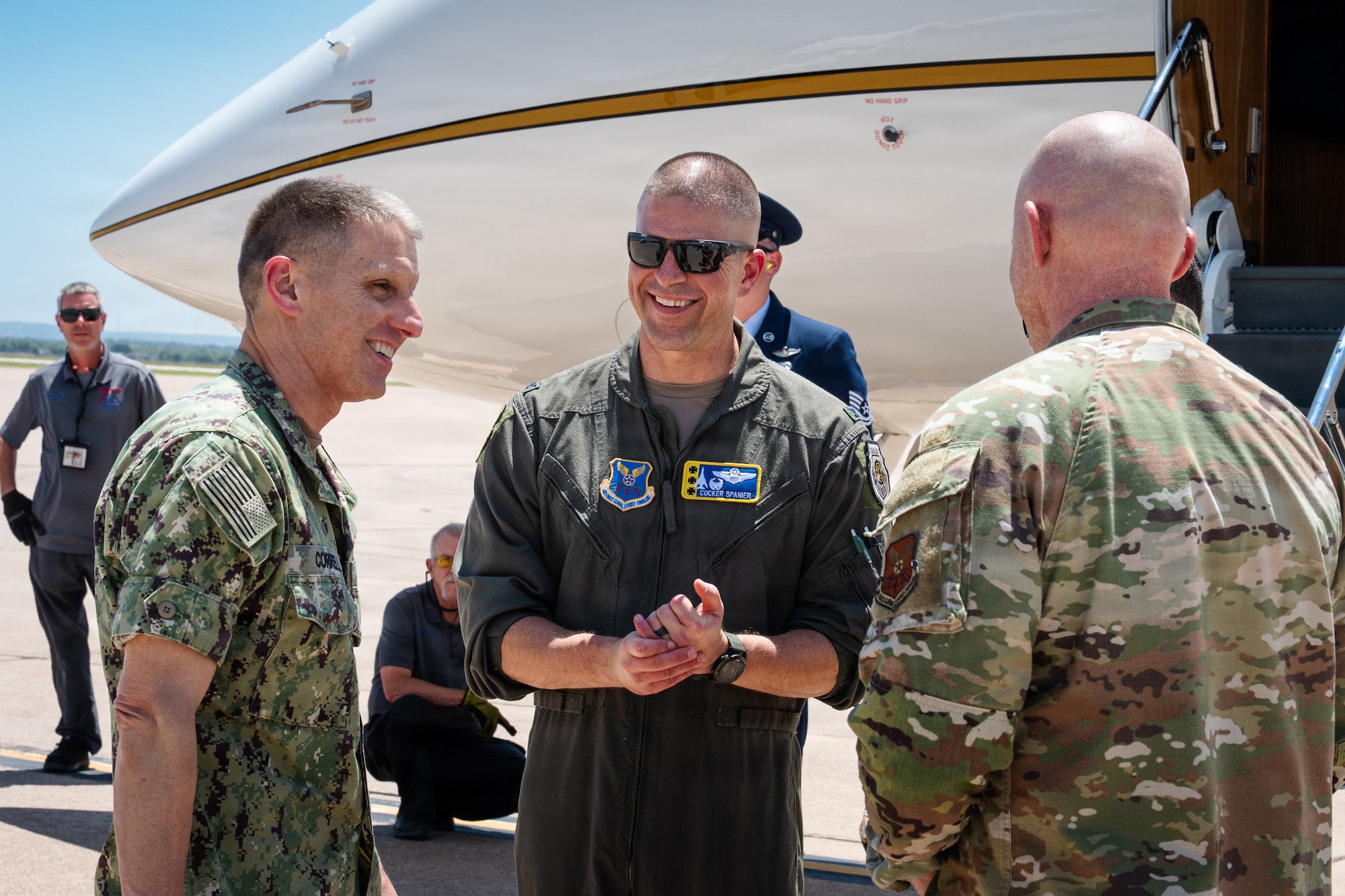 A U.S. Navy Admiral is greeted on the flightline