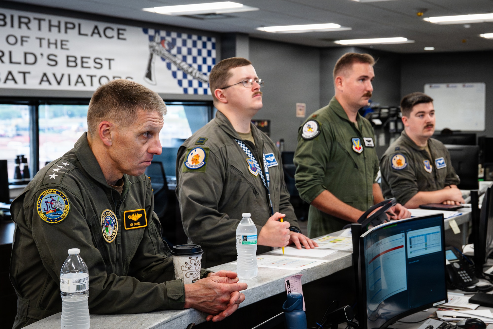 A U.S. Navy Admiral and U.S. Air Force pilots mission brief before a B-1B Lancer flight.