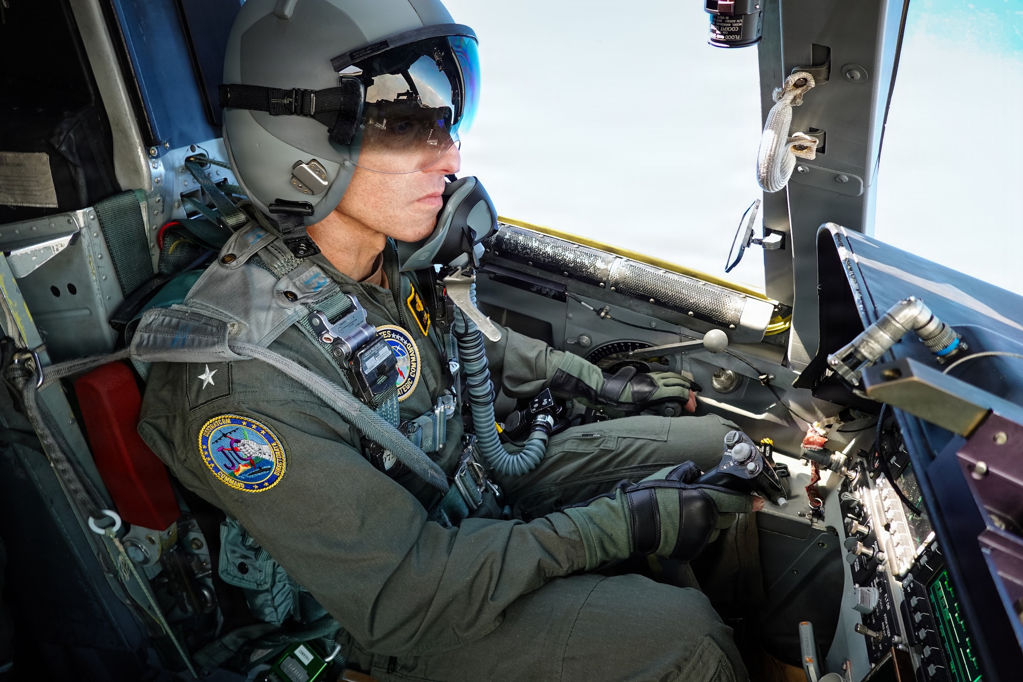 A U.S. Navy Admiral sits in the cockpit of a B-1B Lancer during flight.