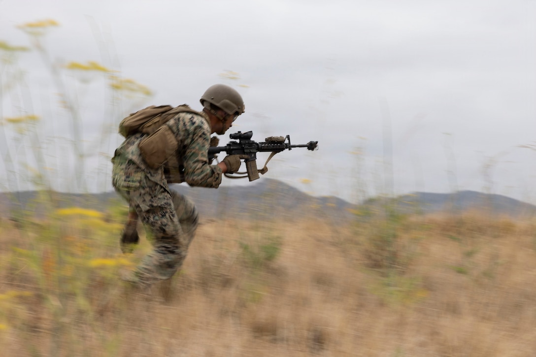 U.S. Marine Corps Sgt. Daniel Fuller, a squad leader with Echo Company, 3d Assault Amphibian Battalion, 1st Marine Division, runs forward during a patrolling exercise at Marine Corps Base Camp Pendleton, California, June 25, 2026. The PEX provides Marines with an opportunity to reinforce and refine skills with communication, patrolling, and coordinating movements under sustained physical and mental pressure in a realistic warfighting scenario. Fuller is a native of California. (U.S. Marine Corps photo by Lance Cpl. Mia Ocampo)