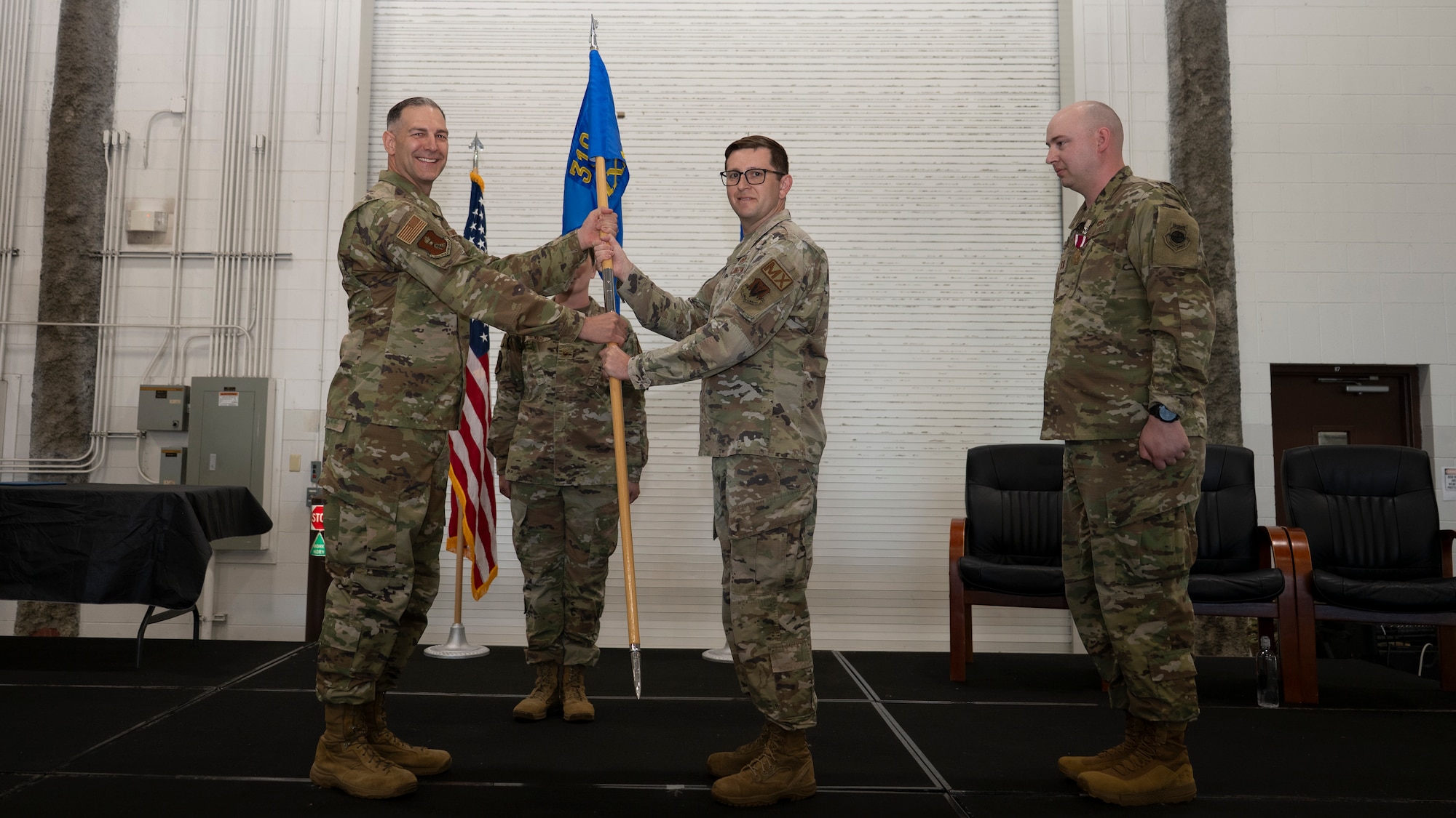 Presiding officer gives squadron guidon to incoming commander.