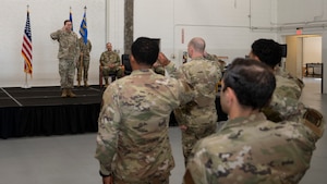 Airmen salute incoming commander at change of command ceremony.
