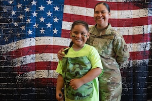 U.S. Air Force Airman 1st Class. Danica Calvo, a public health apprentice assigned to Andrews Operational and Readiness Squadron, and her son attend