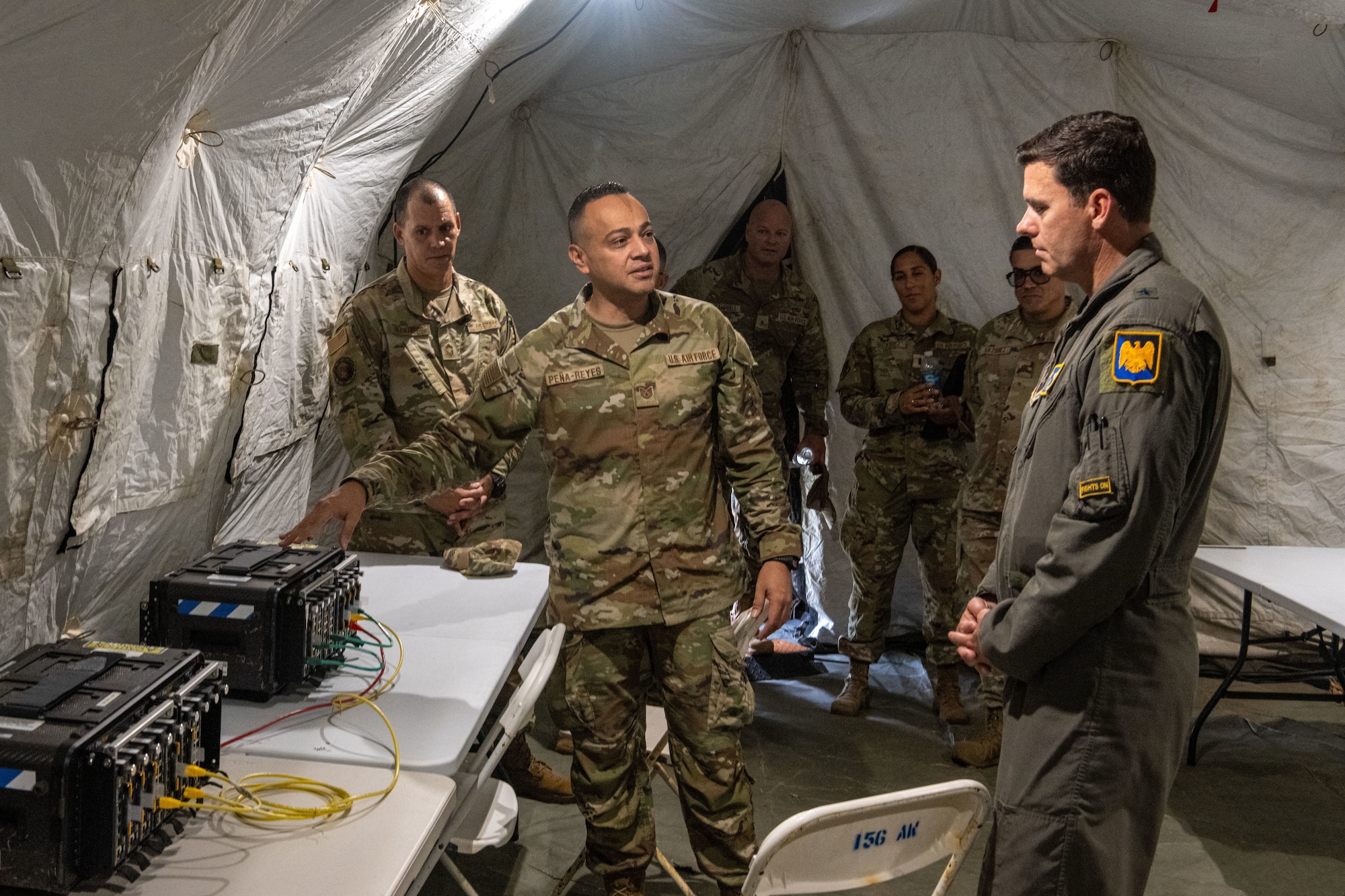 U.S. Air Force Brig. Gen. Jake Hammons, director, plans and programs for the Air National Guard, receives a combat communications capabilities briefing from Tech. Sgt. Jonathan Peña, network operations specialist, 156th Combat Communications Squadron, Puerto Rico Air National Guard, at Punta Salinas Air National Guard Station, Puerto Rico, June 6, 2026. The briefing highlighted how the 156th Wing is integrating new communications capabilities as part of ongoing mission-conversion efforts. (U.S. Air National Guard photo by Lt. Col. Matt Murphy)