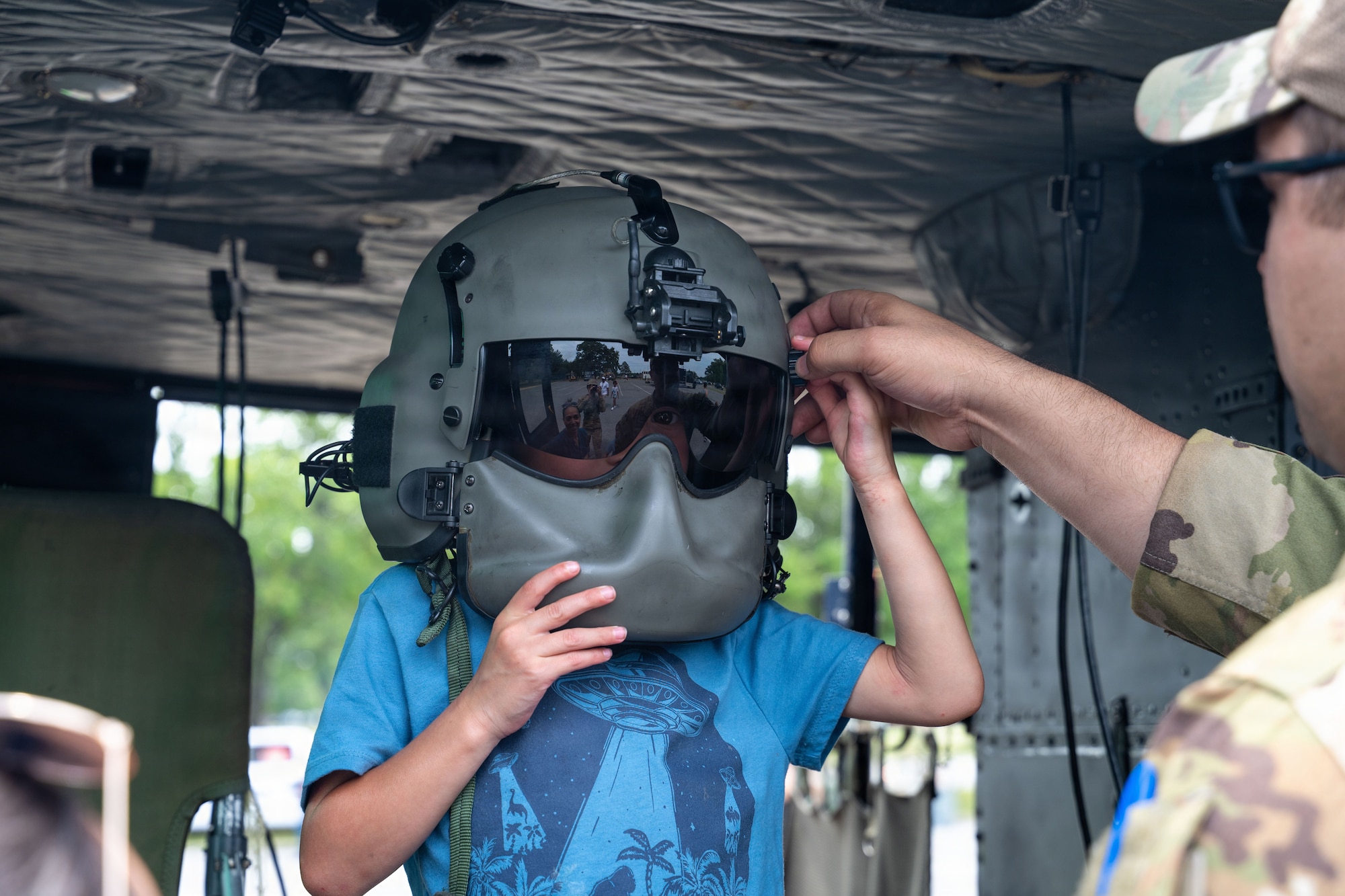 A boy tries on a helmet