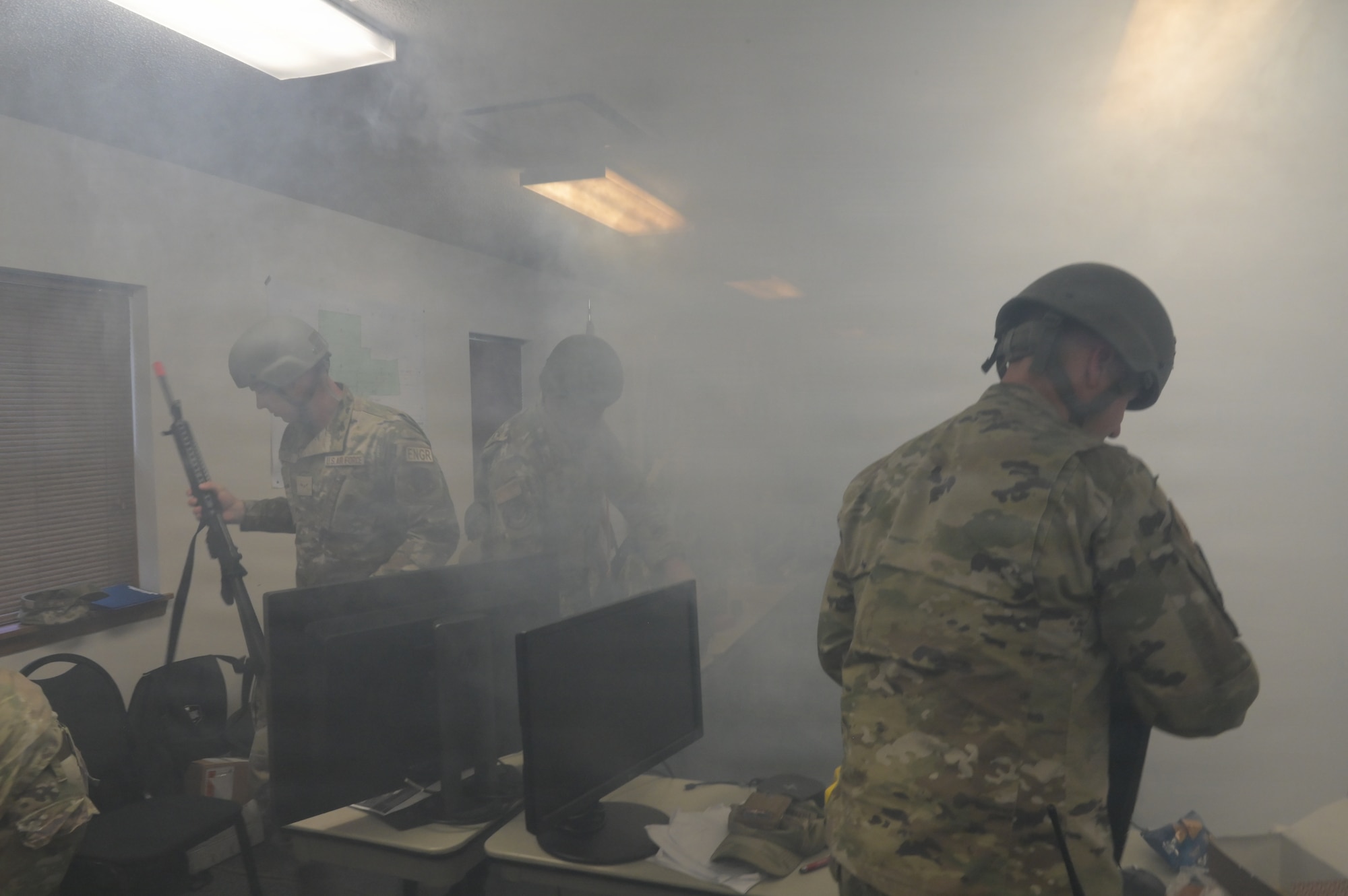 U.S. Airmen assigned to the 115th Fighter Wing, Wisconsin Air National Guard,  evacuate a building during the 115 FW 2026 Combat Readiness Exercise, Operation Iron Orchid, at Volk Field Air National Guard Base, Camp Douglas, Wisconsin, June 24, 2026. Operation Iron Orchid is designed to assess and reinforce the wing’s ability to generate combat capability, sustain operations, protect personnel and resources, respond to evolving conditions, and execute mission-essential tasks in a realistic and challenging environment. (U.S. Air National Guard photo by Tech. Sgt. Zachary Caldwell)