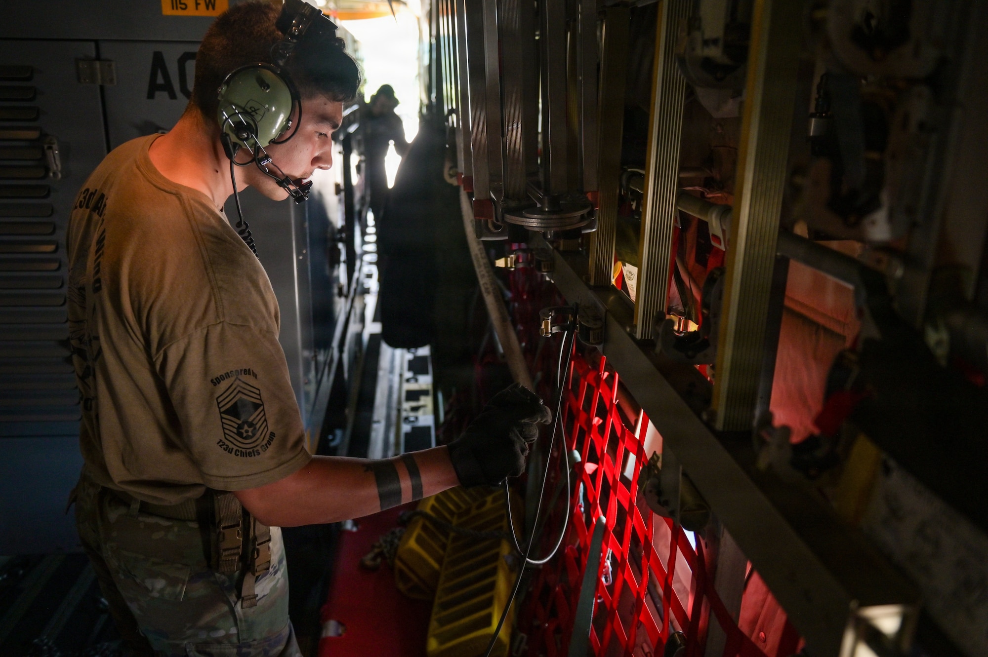 A U.S. Airman assigned to the 123rd Airlift Wing, Kentucky Air National Guard, Louisville, Kentucky, checks equipment while loading a C-130J Super Hercules aircraft during the 115 FW 2026 Combat Readiness Exercise, Operation Iron Orchid, at Volk Field Air National Guard Base, Camp Douglas, Wisconsin, June 26, 2026. Operation Iron Orchid is designed to assess and reinforce the wing’s ability to generate combat capability, sustain operations, protect personnel and resources, respond to evolving conditions, and execute mission-essential tasks in a realistic and challenging environment. (U.S. Air National Guard photo by Senior Airman Jessica Duch)