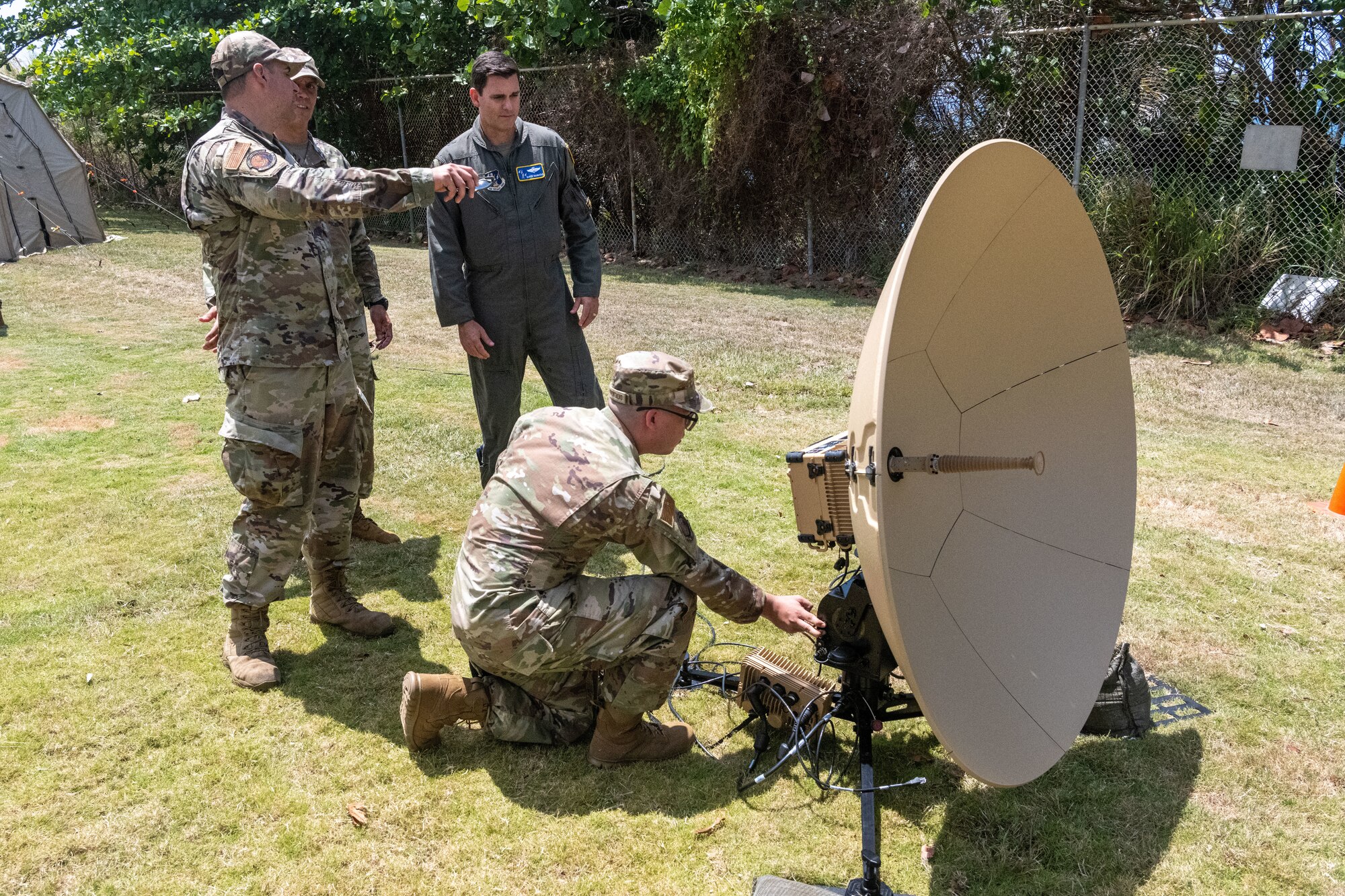 U.S. Air Force Airman 1st Class Miguel Serrano, radio frequency transmissions systems apprentice, 156th Combat Communications Squadron, Puerto Rico Air National Guard, demonstrates a TAMPA 1.3 antenna for Brig. Gen. Jake Hammons, director, plans and programs for the Air National Guard, at Punta Salinas Air National Guard Station, Puerto Rico, June 6, 2026. The self-calibrating antenna can be set up by one Airman in approximately 30 minutes, increasing the unit’s ability to provide expeditionary communications in austere or rapidly changing environments. (U.S. Air National Guard photo by Lt. Col. Matt Murphy)