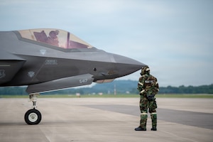 A U.S. Airman assigned to the 115th Fighter Wing, Wisconsin Air National Guard, conducts flight line operations in mission-oriented protective posture gear during a combat readiness exercise, Operation Iron Orchid, at Volk Field Air National Guard Base, Camp Douglas, Wisconsin, June 26, 2026. Operation Iron Orchid is designed to assess and reinforce the wing’s ability to generate combat capability, sustain operations, protect personnel and resources, respond to evolving conditions, and execute mission-essential tasks in a realistic and challenging environment. (U.S. Air National Guard photo by Airman Alec Martin)
