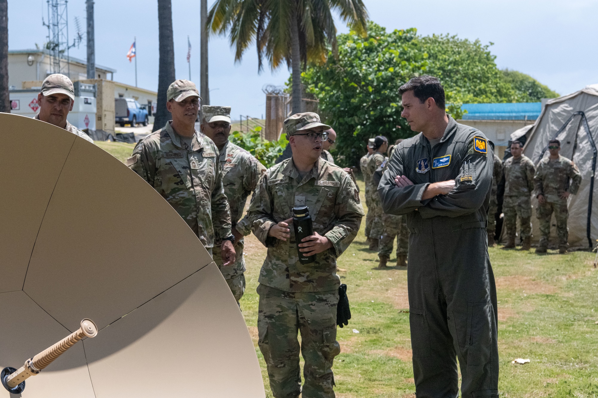 U.S. Air Force Airman 1st Class Miguel Serrano, radio frequency transmissions systems apprentice, 156th Combat Communications Squadron, Puerto Rico Air National Guard, demonstrates a TAMPA 1.3 antenna for Brig. Gen. Jake Hammons, director, plans and programs for the Air National Guard, at Punta Salinas Air National Guard Station, Puerto Rico, June 6, 2026. The self-calibrating antenna can be set up by one Airman in approximately 30 minutes, increasing the unit’s ability to provide expeditionary communications in austere or rapidly changing environments. (U.S. Air National Guard photo by Lt. Col. Matt Murphy)
