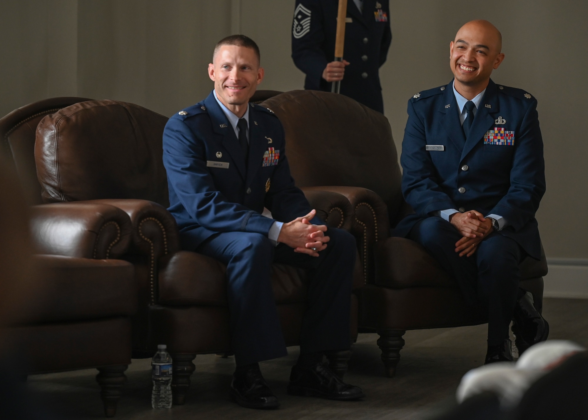 U.S. Air Force Lt. Col. Andrew Atkinson, (right), incoming commander of Air Combat Command Operations Analysis Squadron and Lt. Col. Micah Hafich outgoing commander of the ACC OAS, smile during the ACC OAS change of command ceremony.
