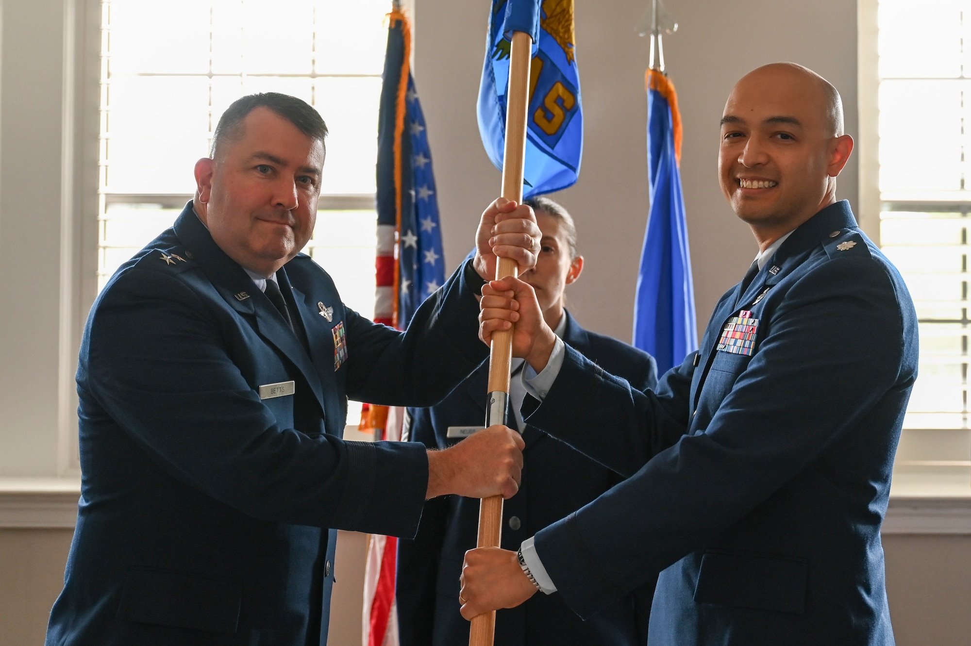 U.S. Air Force Lt. Col. Andrew Atkinson (right) accepts the Air Combat Command Operations Analysis Squadron (OAS) guidon from Maj. Gen. William Betts, Director of Plans, Programs and Requirements, Headquarters ACC, during the ACC OAS change of command ceremony.