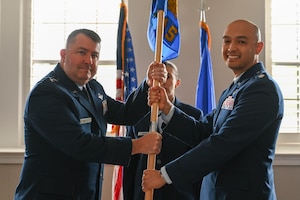 U.S. Air Force Lt. Col. Andrew Atkinson (right) accepts the Air Combat Command Operations Analysis Squadron (OAS) guidon from Maj. Gen. William Betts, Director of Plans, Programs and Requirements, Headquarters ACC, during the ACC OAS change of command ceremony.