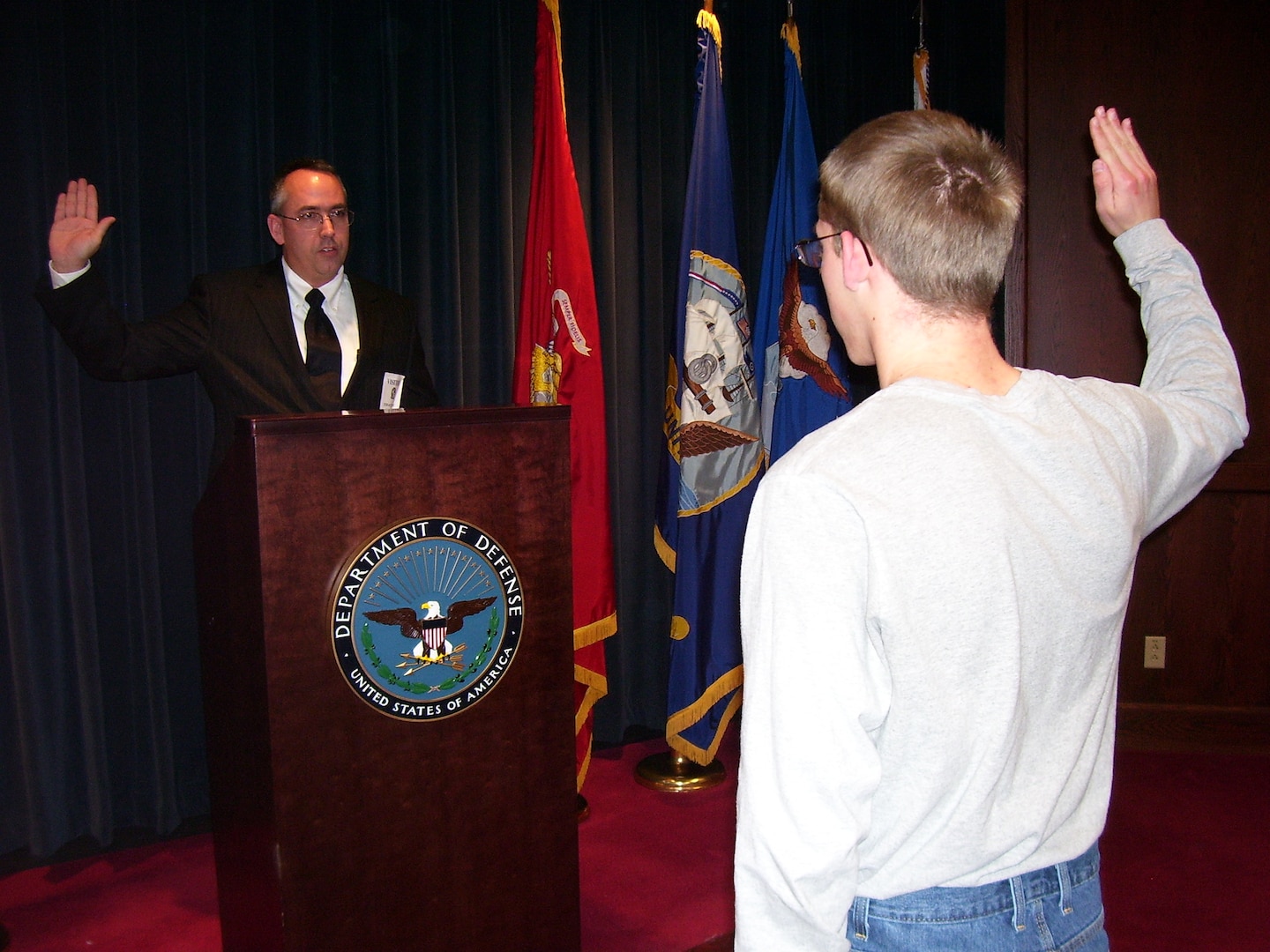 Retired Air Force Maj. Kenneth McDonald administers the oath of enlistment to his son, David, at the Syracuse MEPS. McDonald has administered the oath of enlistment for 3 of his sons at the Syracuse MEPS.