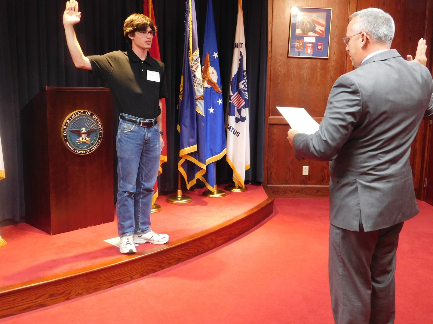 Retired Air Force Maj. Kenneth McDonald administers the oath of enlistment to his son, Daniel, at the Syracuse MEPS. McDonald has administered the oath of enlistment for 3 of his sons at the Syracuse MEPS.