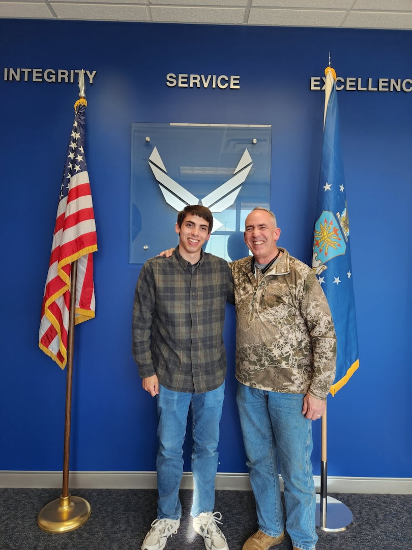 Retired Air Force Maj. Kenneth McDonald poses with his son, Benjamin, at the Syracuse MEPS after administering the oath of enlistment. McDonald has administered the oath of enlistment for 3 of his sons at the Syracuse MEPS.