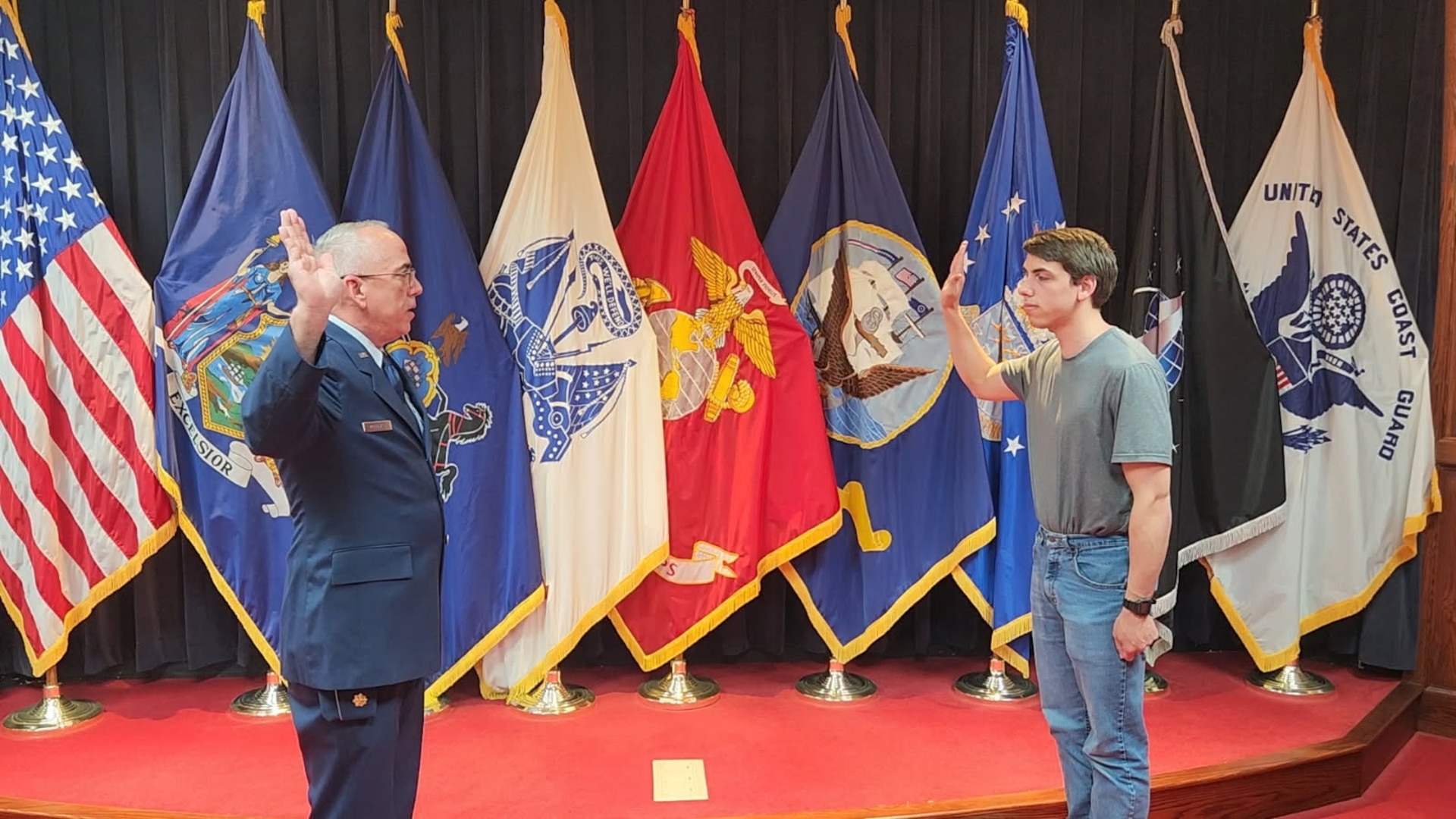Retired Air Force Maj. Kenneth McDonald administers the oath of enlistment to his son, Benjamin, at the Syracuse MEPS. McDonald has administered the oath of enlistment for 3 of his sons at the Syracuse MEPS.