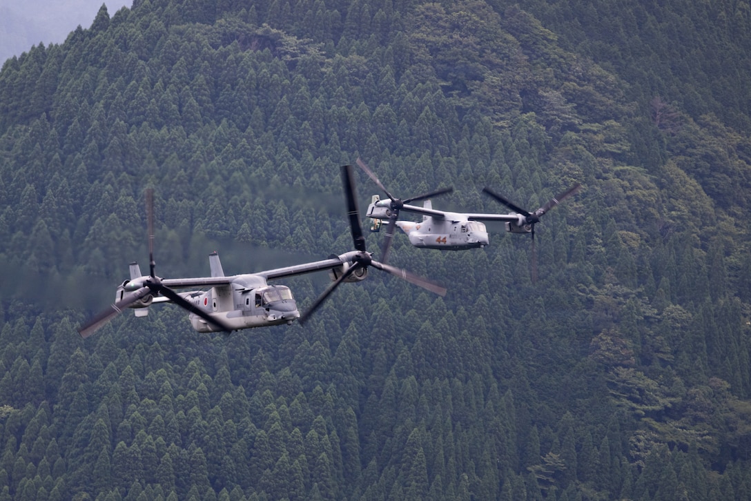 A Japan Ground Self-Defense Force V-22 Osprey tiltrotor aircraft, left, and a U.S. Marine Corps MV-22B Osprey tiltrotor aircraft with Marine Medium Tiltrotor Squadron 262, Marine Aircraft Group 36, 1st Marine Aircraft Wing, fly over Kumamoto, Japan during Resolute Dragon 26, June 21, 2026. Resolute Dragon is an annual bilateral exercise in Japan that strengthens the command, control, and multi-domain maneuver capabilities of U.S. Marines in III Marine Expeditionary Force and Japan Self-Defense Force personnel, with a focus on controlling and defending key maritime terrain.  (U.S. Marine Corps photo by Lance Cpl. Carlos Paz-Sosa)