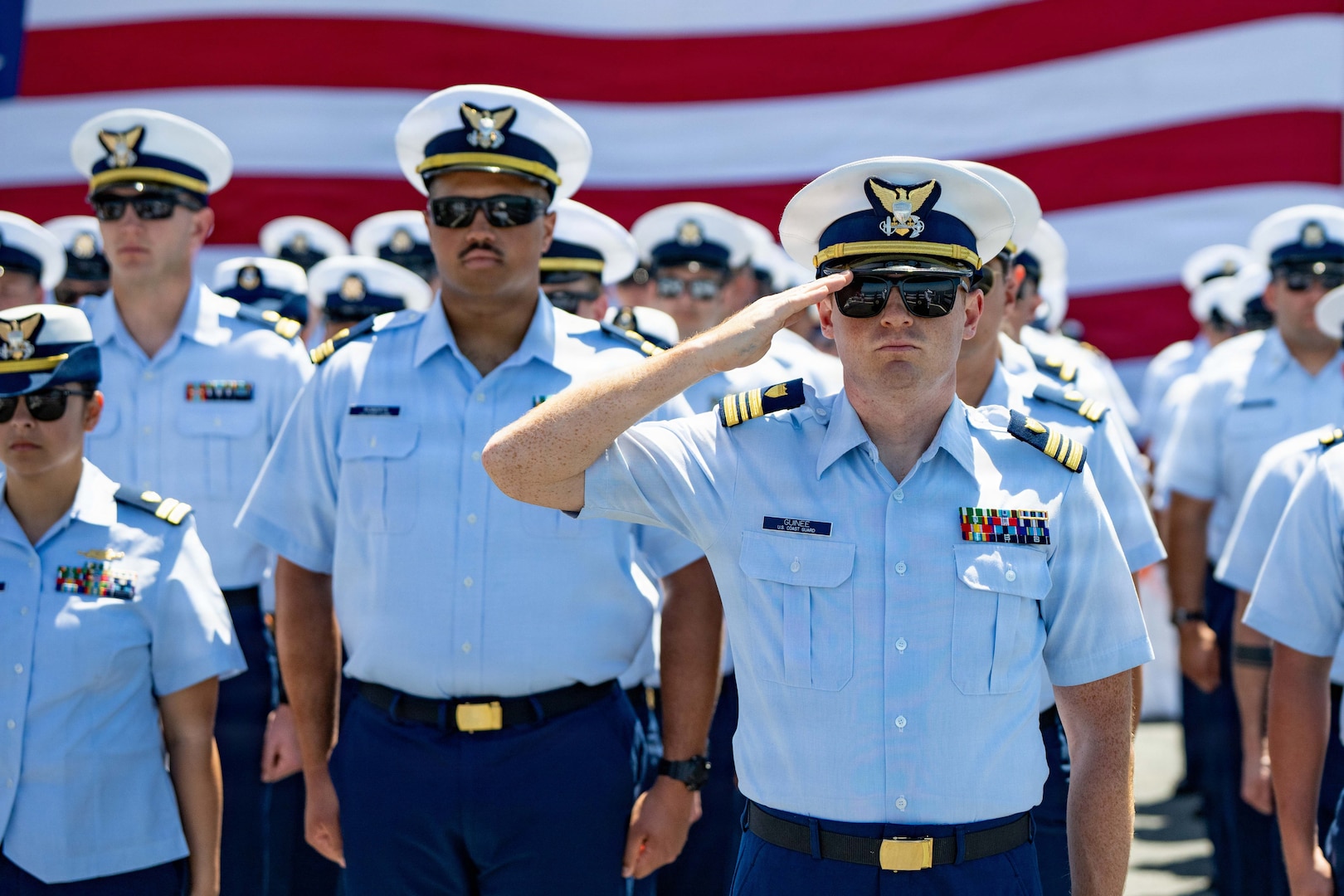 U.S. Coast Guard Cutter Munro (WMSL 755) crew members stand at attention for the national anthem during the cutter's change-of-command ceremony in San Diego, June 26, 2026. Munro is a Legend-class national security cutter and carries out a variety of missions including counter-narcotics and the protection of fisheries. (U.S. Coast Guard photo by Petty Officer 3rd Class Chris Sappey)