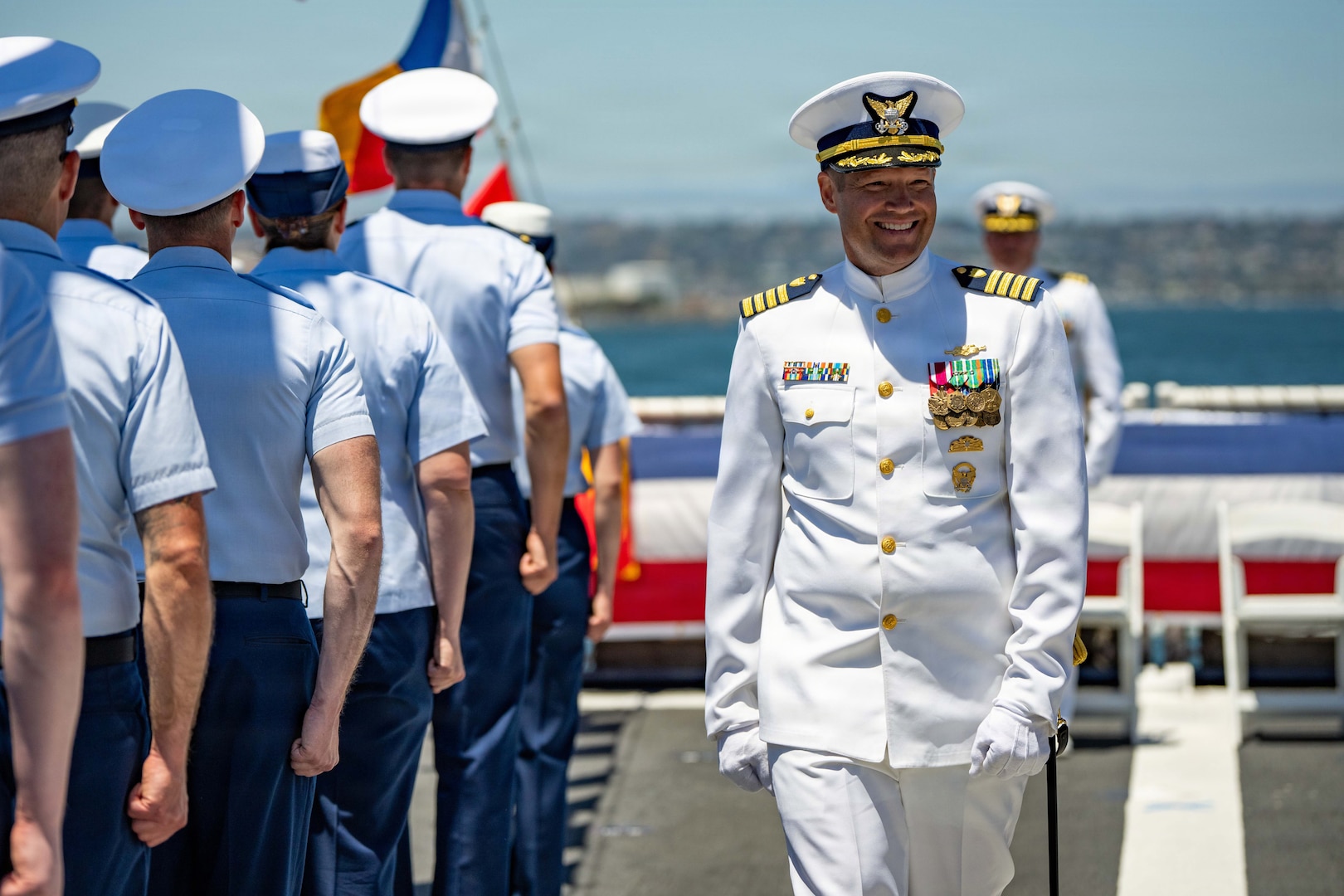 U.S. Coast Guard Capt. Adam Disque exits the change of command ceremony aboard Coast Guard Cutter Munro (WMSL 755) in San Diego, June 26, 2026. Disque was appointed as the commanding officer of Munro after previous serving as the commanding officer of Coast Guard Cutter Active (WMEC 618). (U.S. Coast Guard photo by Petty Officer 3rd Class Chris Sappey)