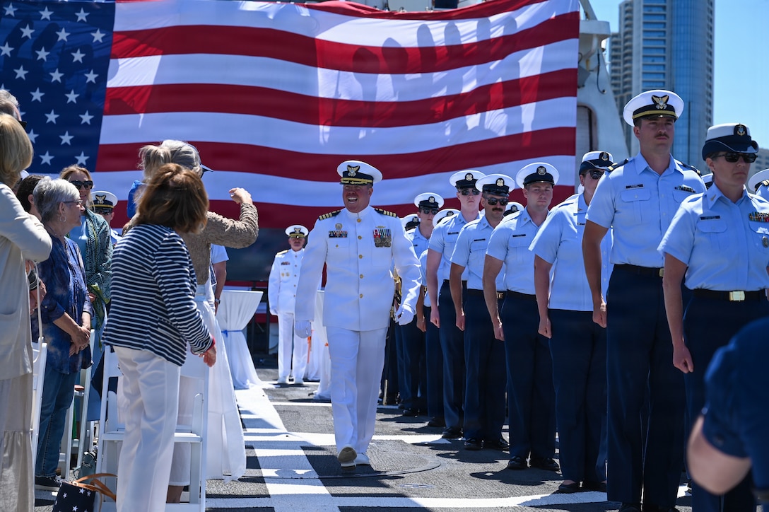 Capt. James O'Mara walks down the center aisle as the commanding officer of Coast Guard Cutter Munro (WMSL 755) for the final time before the change-of-command ceremony in San Diego, June 26, 2026. A change-of-command ceremony is a time-honored military tradition that formally transfers authority and responsibility from one commanding officer to another while reaffirming the continuity of command. (U.S. Coast Guard photo by Petty Officer 3rd Class Trinity Whalen)