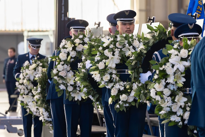 Airmen of the Blue Eagles Honor Guard, on behalf of “Torch 11” family members, prepare to attach wreaths to easels holding the images of the fallen B-52 aircrew. More than 1,000 people, including Air Force Chief of Staff Gen. Ken Wilsbach and Chief Master Sergeant of the Air Force David Wolfe, gathered in an Edwards aircraft hanger June 29 to celebrate the lives of Col. Gregory “Evil” Watson, Lt. Col. Gabriel “Journee” Estrella, retired Lt. Col. Miles “Vicky” Middleton, Maj. Alexander “SMO” Davis, Maj. Robert “Bolton” Dee, Maj. Brad “Slate” Hovey, Jeromy “Bobby” Smith and Christopher “Hustler” Rischar. (Air Force photo by Lindsey Gordon).
