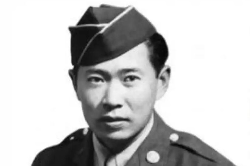 A man is wearing a military dress uniform.