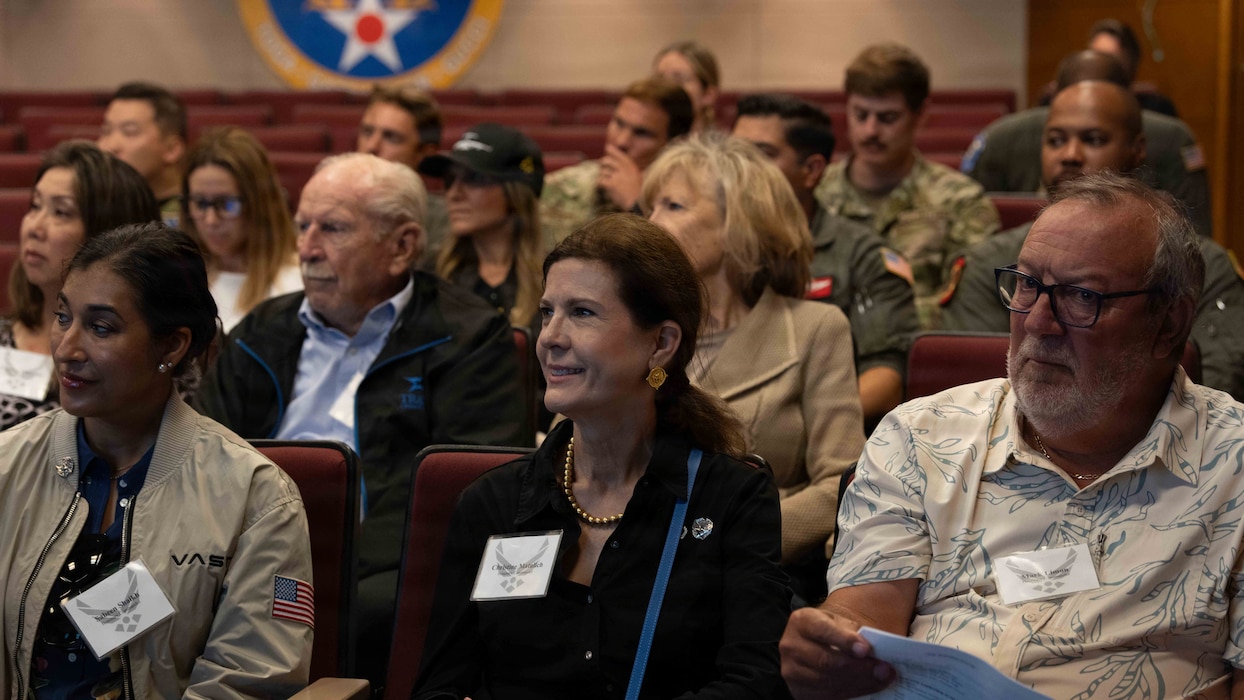 Honorary commanders listen to a briefing.