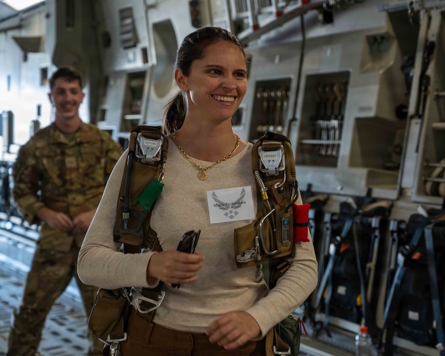 Honorary commander tries on a harness.
