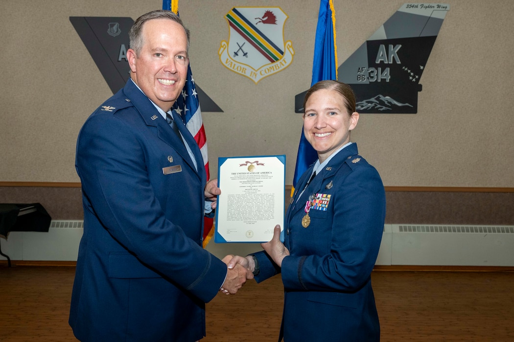 U.S. Air Force Lt. Col. Michelle Ground, 354th Force Support Squadron commander, right, receives the Meritorious Service Medal from U.S. Air Force Col. Timothy Foster, 354th Mission Support Group commander, during a change of command ceremony at Eielson Air Force Base, Alaska, June 26, 2026.