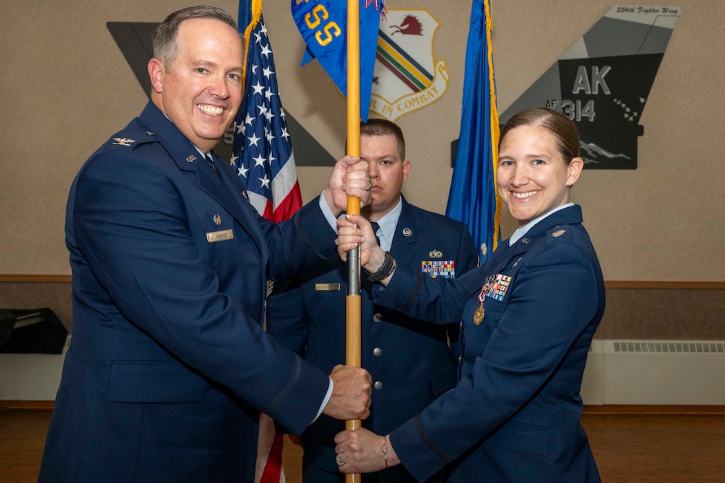 U.S. Air Force Lt. Col. Michelle Ground, right, relinquishes command of the 354th Force Support Squadron to U.S. Air Force Col. Timothy Foster, 354th Mission Support Group commander, during a change of command ceremony at Eielson Air Force Base, Alaska, June 26, 2026.