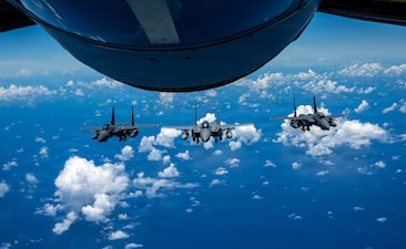 A U.S. Air Force F-15EX Eagle II and F-15E Strike Eagles assigned to the 85th Test and Evaluation Squadron, Eglin Air Force Base, Florida, fly in formation after receiving fuel from a KC-135 Stratotanker assigned to the 909th Air Refueling Squadron over the Pacific Ocean, June 29, 2026