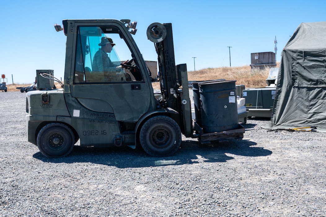 U.S. Air Force Staff Sgt. Devon Klostermann, a student assigned to the Air Force Combat Ammunition Center Class 26-006, uses a forklift to move barrels during a fragmentation order preparation exercise at Beale Air Force Base, California, June 12, 2026.