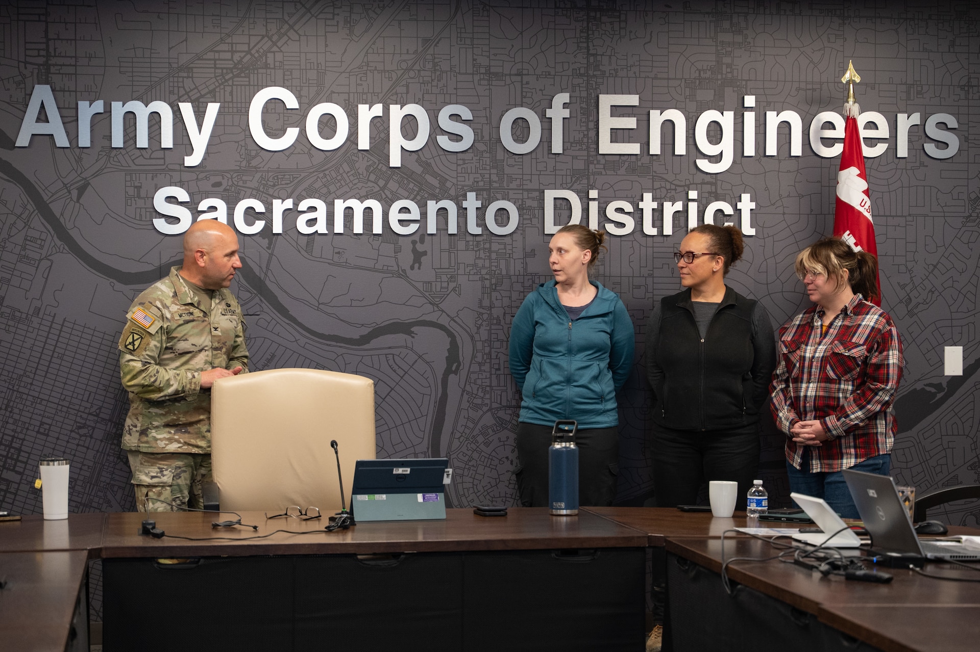 Sacramento District Commander Col. Robert McTighe (left) presents a commander's coin to (from left) Shelley McCoy, Jerilynn Hilmar and Elizabeth "Ellie" Hayes Dec. 8, 2025, at Sacramento District headquarters. The three employees were recognized for their quick response to a medical emergency, drawing on their training and past experiences to assist a distressed colleague and help facilitate the medical attention she needed
