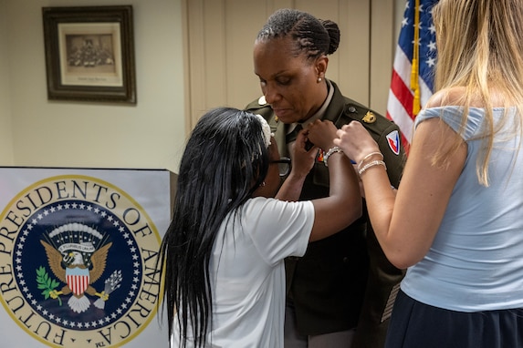 Students participating a Future Presidents of America program present a special pin to Command Sgt. Maj. Joy L. Allen, U.S. Army Financial Management Command senior enlisted advisor, at the Benjamin Harrison Presidential Site in Indianapolis June 30, 2026. The site’s Future Presidents of America program is a youth leadership camp with a mission of developing individual confidence, civic literacy and good citizenship to reveal the exceptional qualities of character that make for great presidents and leaders. (U.S. Army photo by Mark R. W. Orders-Woempner)