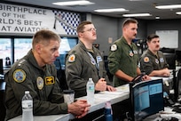 A U.S. Navy Admiral and U.S. Air Force pilots mission brief before a B-1B Lancer flight.