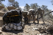 Utah National Guard Soldiers assigned to the 19th Special Forces Group (Airborne), attach a cargo net holding dinosaur bones to a UH-60 Black Hawk during an air lift in southern Utah, June 13, 2026.
