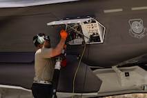 A U.S. Air Force Airman assigned to the 99th Logistics Readiness Squadron fuels an F-35A Lightning II during a hot integrated combat turn (ICT) exercise at Creech Air Force Base, Nevada, June 17, 2026. During Hot ICTs, crews load inert medium-range air-to-air missiles while simultaneously refueling the aircraft with engines running, enabling rapid sortie generation. (U.S. Air Force photo by Staff Sgt. Jake Jacobsen)