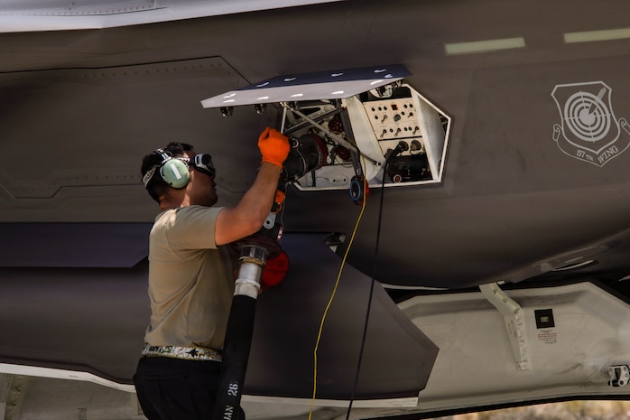 A U.S. Air Force Airman assigned to the 99th Logistics Readiness Squadron fuels an F-35A Lightning II during a hot integrated combat turn (ICT) exercise at Creech Air Force Base, Nevada, June 17, 2026. During Hot ICTs, crews load inert medium-range air-to-air missiles while simultaneously refueling the aircraft with engines running, enabling rapid sortie generation. (U.S. Air Force photo by Staff Sgt. Jake Jacobsen)