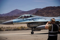 A U.S. Air Force F-16C Fighting Falcon aircraft assigned to the 64th Aggressor Squadron taxis to the runway during exercise VENOM FORGE at Creech AFB June 17, 2026. The exercise was the capstone event for a course aimed at familiarizing Airmen with commander’s intent, communication under friction, generating aircraft, and creating the conditions for combat airpower to take place. (U.S. Air Force photo by Staff Sgt. Jake Jacobsen)