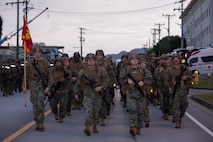 U.S. Marines with Combat Logistics Regiment 35, 3rd Marine Logistics Group, participate in a 5-kilometer conditioning hike during a physical training session on Camp Schwab, Okinawa, Japan, Feb. 27, 2026. The purpose of this hike was to condition Marines with nuanced training while fostering discipline, camaraderie and mental toughness across ranks. (U.S. Marine Corps photo by Cpl. Eric Allen)