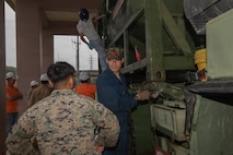 U.S. Marine Corps Lance Cpl. Gianni MartinezCordova, left, a motor vehicle operator, and Lance Cpl. Thomas Pencis, a semitrailer refueler operator, both with 3rd Landing Support Battalion, Combat Logistics Regiment 3, 3rd Marine Logistics Group, conduct a joint fuel transport operation alongside civilian Defense Logistics Agency workers at DLA Defense Fuel Supply Point, Okinawa, Japan, Feb. 25, 2026. U.S. Marines with 3rd MLG conducted continuous joint fuel transport operations with U.S. Air Force 18th Logistics Readiness Squadron and DLA civilians in order to develop efficient practices and gain valuable joint training experience.  (U.S. Marine Corps photo by Lance Cpl. Marcus Henson)