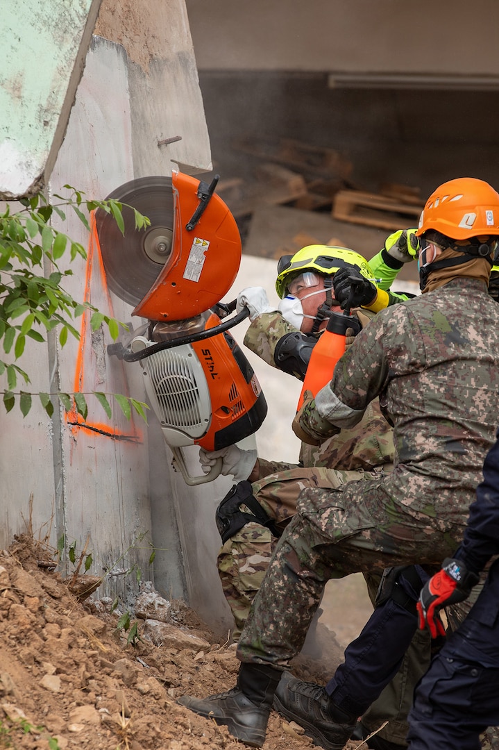 U.S. Air Force Tech. Sgt. Waylon Dashiell, 141st Civil Engineers, Washington Air National Guard, cuts a concrete wall alongside the Bangkok Fire and Rescue Department during the humanitarian assistance disaster relief demonstration, part of Exercise Cobra Gold 2026 at the Disaster Relief Training Centre, Phanom Sarakham District, Chachoengsao, Thailand, Feb. 27, 2026.