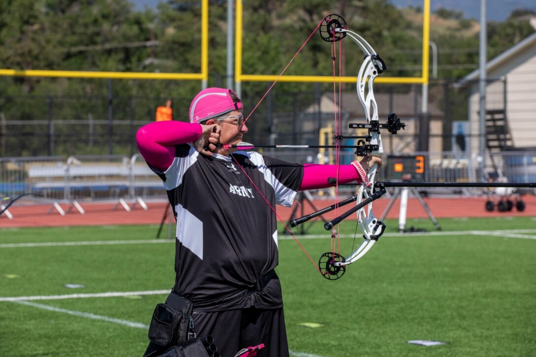 U.S. Army Master Sgt. Jodi Pyle-Vandersys aims her arrow at a target during the archery event.